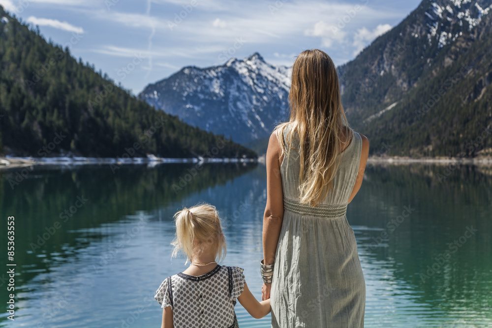 Austria, Tyrol, Lake Plansee, mother and daughter at lakeshore Austria, Tyrol, Lake Plansee, mother and daughter at lakeshore