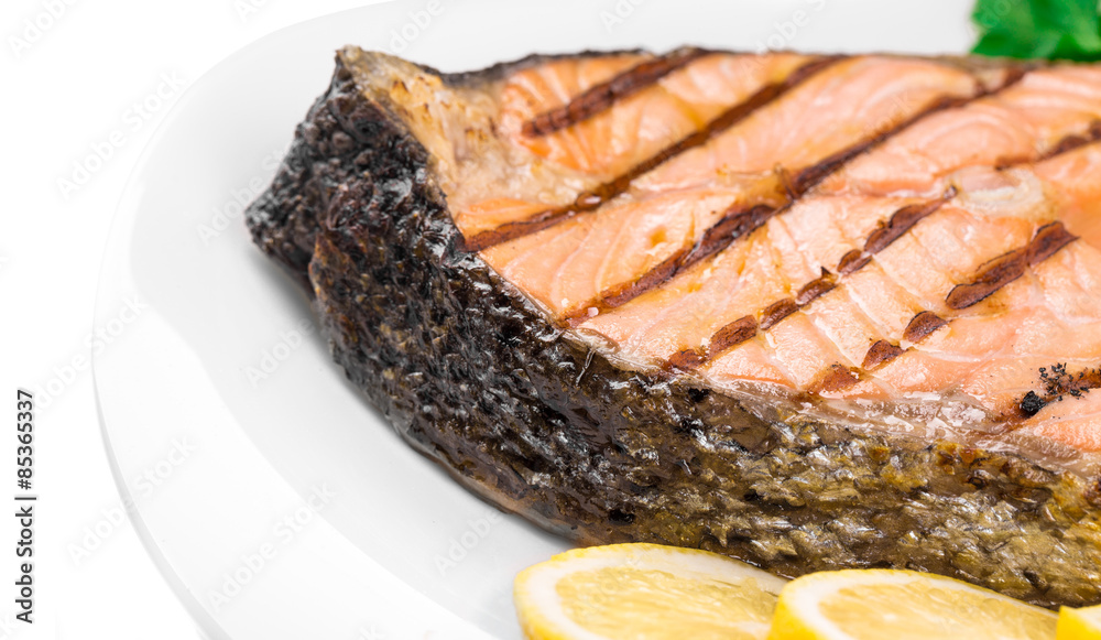 Grilled salmon steak with vegetables on plate. Grilled salmon steak with vegetables on plate.