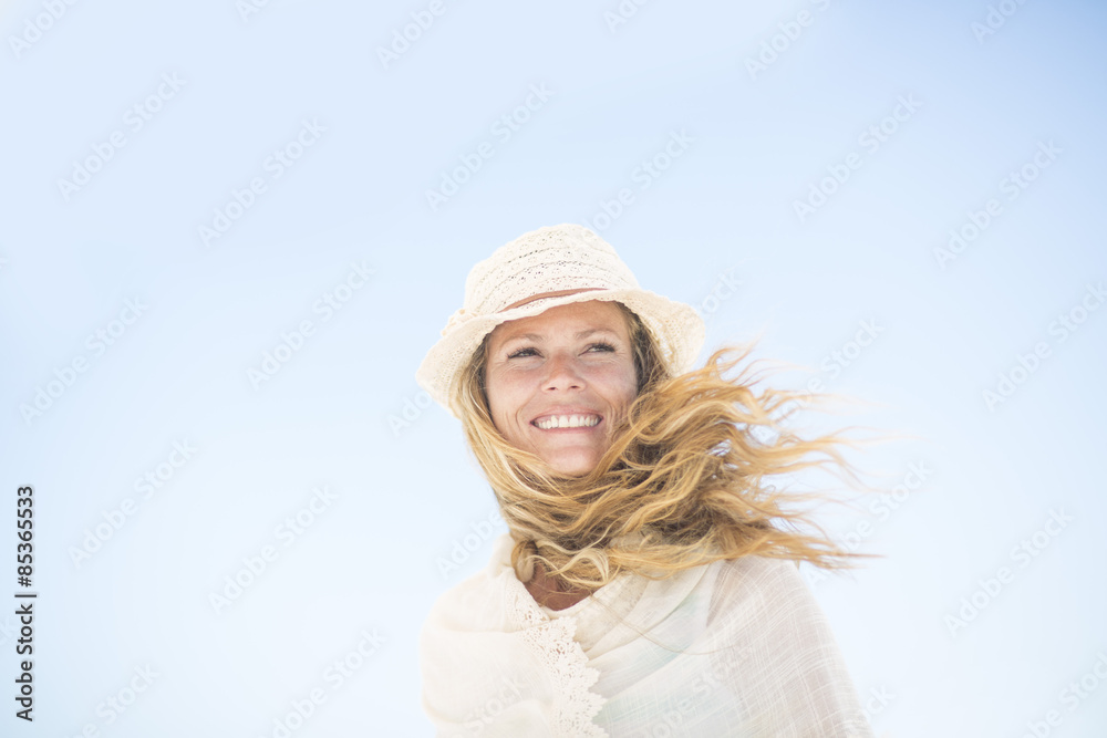 Smiling woman under blue sky Smiling woman under blue sky