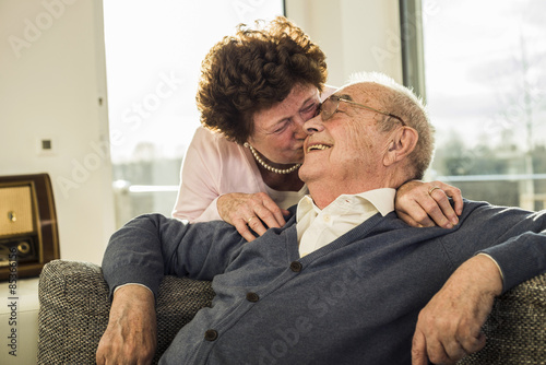 Senior woman kissing her husband
