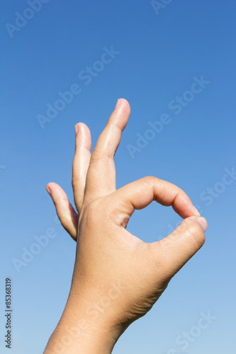 hand ok sign on sky background