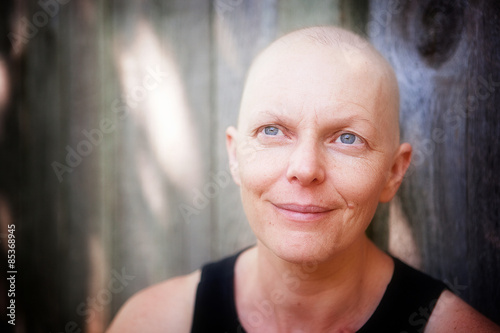 Portrait of a balding cancer patient outside looking off camera 