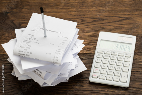 Receipts With Calculator On Table photo