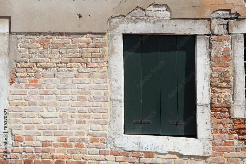 Old gungy wall with immured window