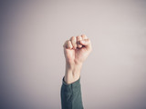 Clenched fist against purple background