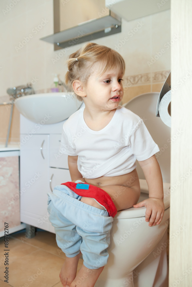 little girl sitting on toilet Stock Photo Adobe Stock