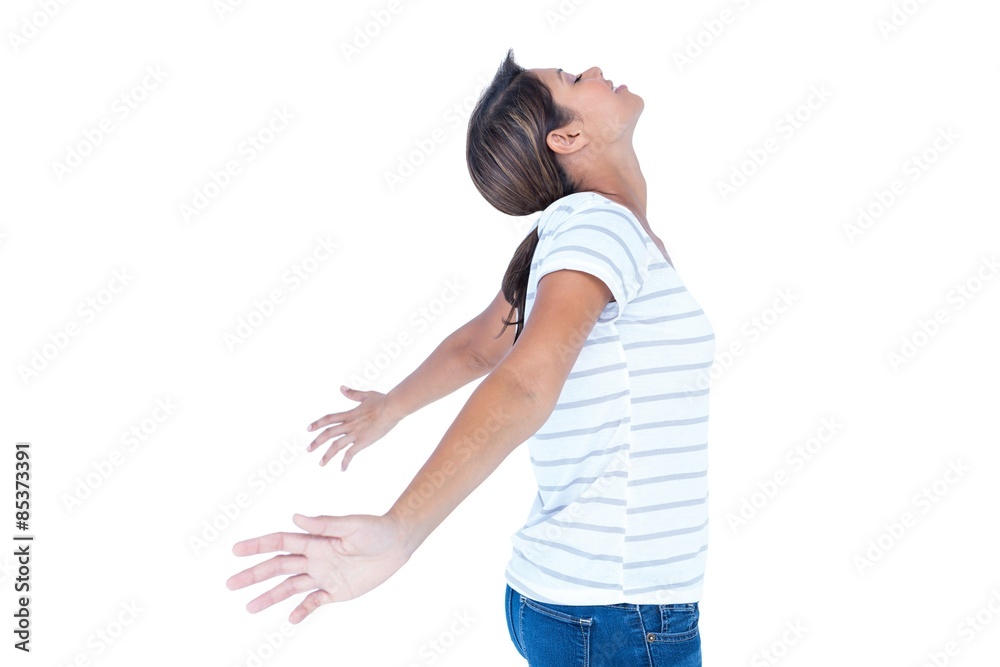 Side view of pretty brunette with arms outstretched 