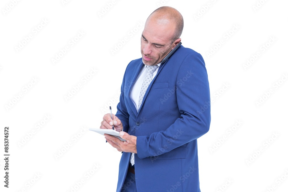 Young businessman writing on a notepad Young businessman writing on a notepad