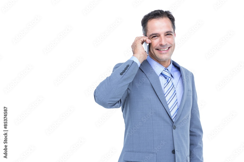 Portrait of a successful businessman on phone against white Portrait of a successful businessman on phone against white