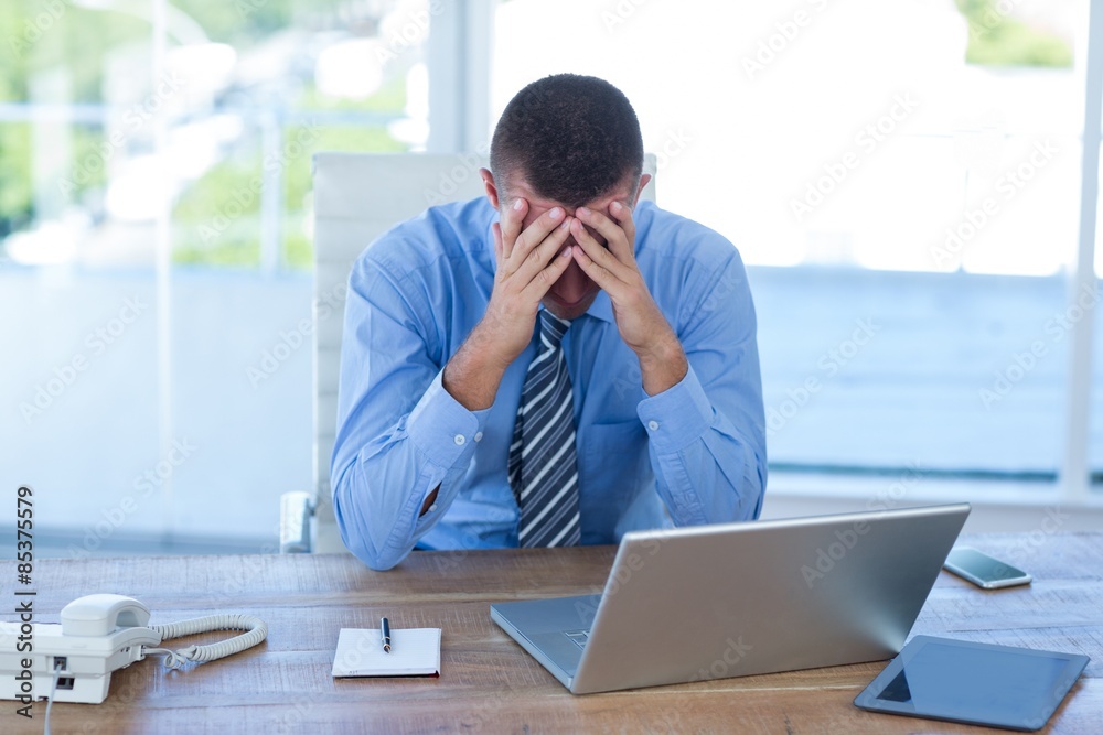 Worried businessman with head in hands Worried businessman with head in hands