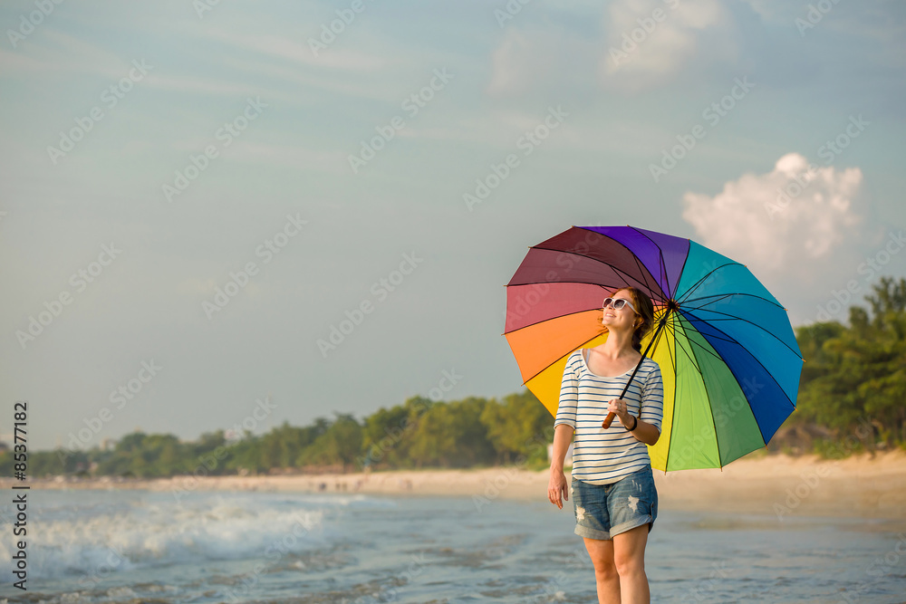 Young caucasian woman wearing sunglasses with colourful rainbow