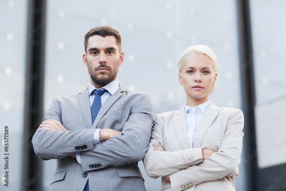 serious businessmen standing over office building serious businessmen standing over office building