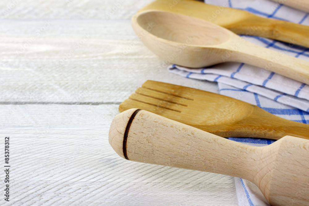 Wooden kitchen utensils in the kitchen napkin on wooden background