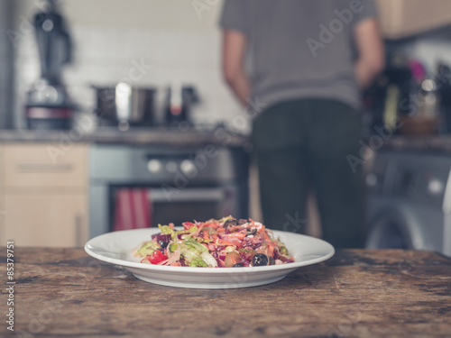 Plate with salad in kitchen