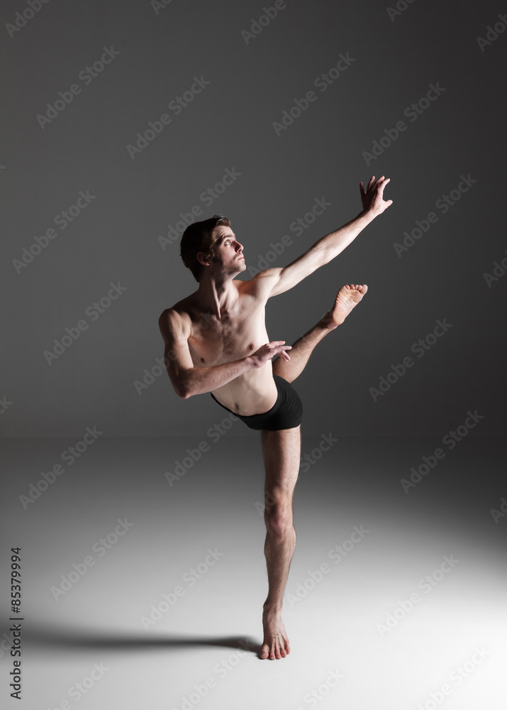 The young attractive modern ballet dancer on white background