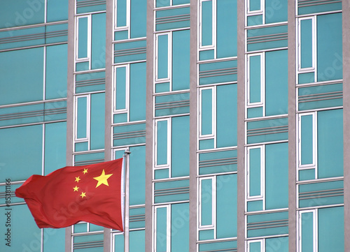 Chinese flag with modern office building. The picture was taken in New York in 2014.