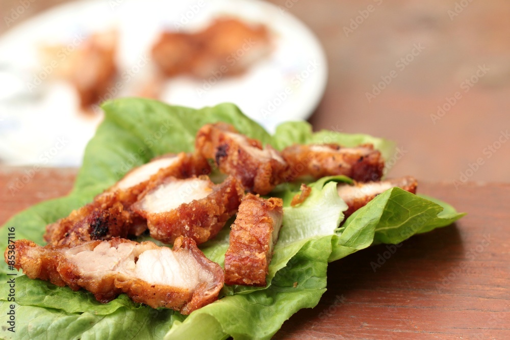 Pork fried with vegetables on wood background. Pork fried with vegetables on wood background.
