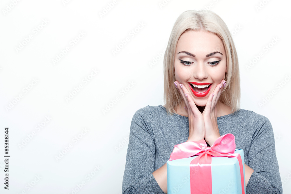 Amazed blond-haired woman getting present Amazed blond-haired woman getting present