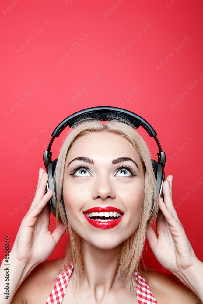 Young blond-haired woman with headphones Young blond-haired woman with headphones