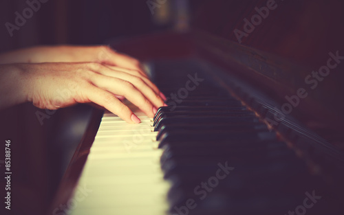 hands of woman pianist on piano keyboard