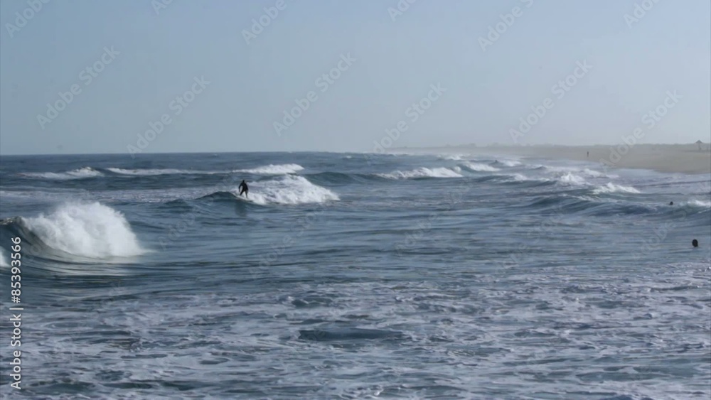People surfing in Tavira Island coast beach, Algarve. People surfing in Tavira Island coast beach, Algarve.