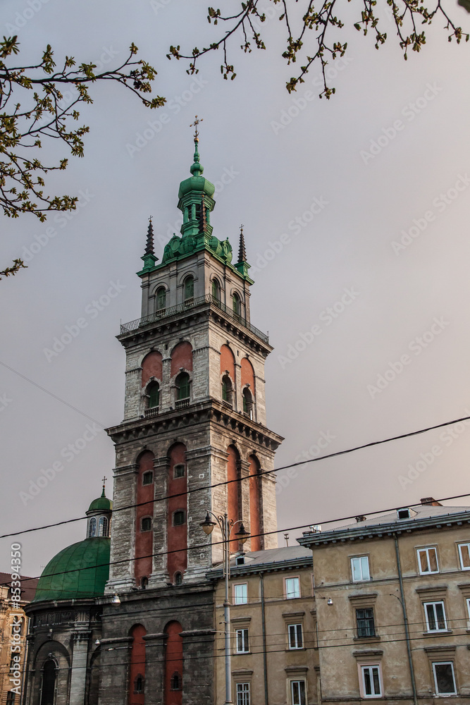 Fototapeta premium Church tower over ancient city landscape