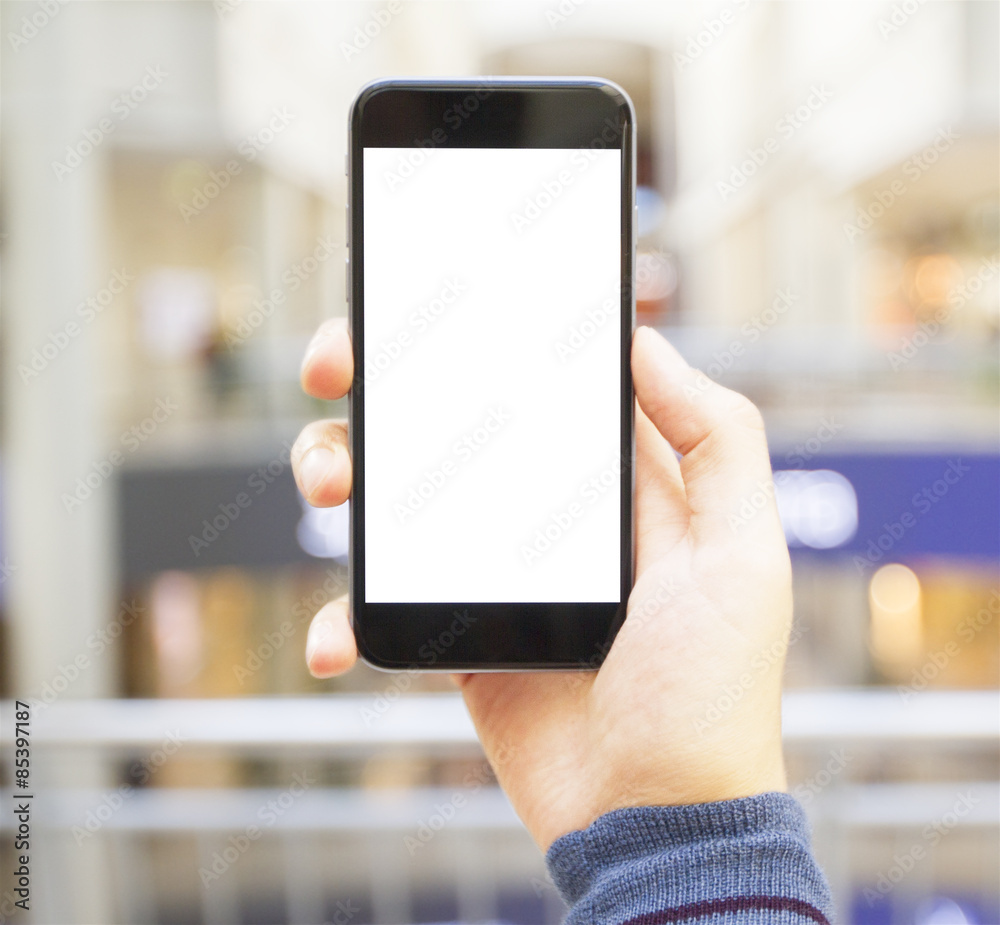 hand with empty cell phone on blurred background hand with empty cell phone on blurred background