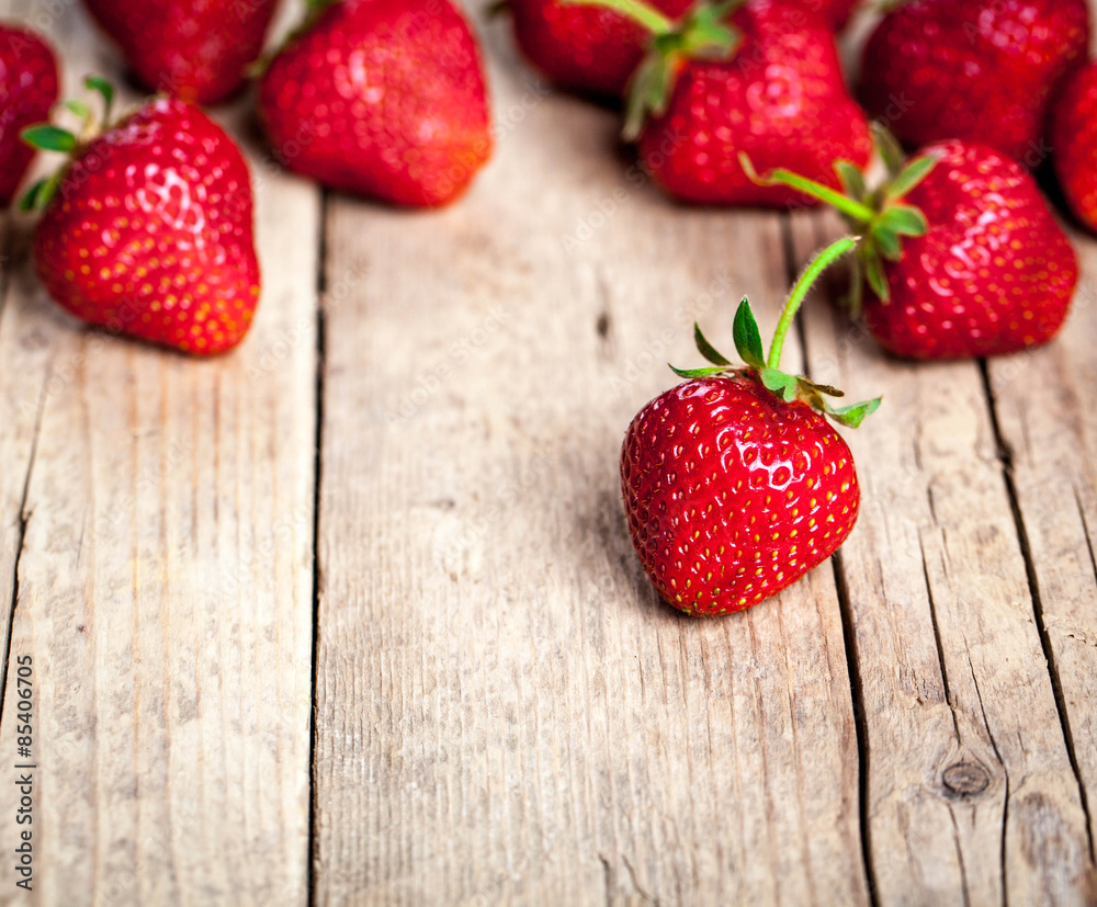 Fresh strawberries on a wooden background. fruit