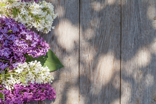 Fototapeta Naklejka Na Ścianę i Meble -  Colorful lilac flowers on garden table