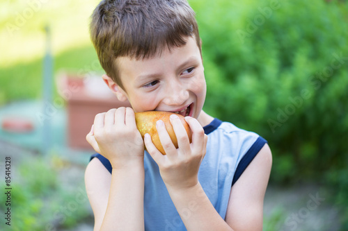 Little boy eating pears