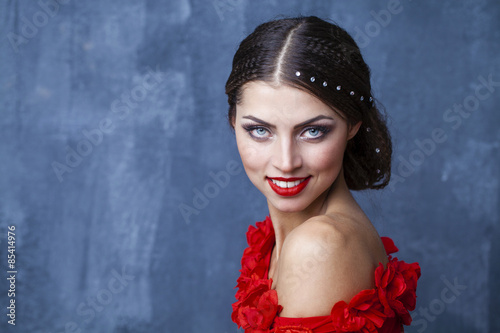 Woman traditional Spanish Flamenco dancer dancing in a red dress