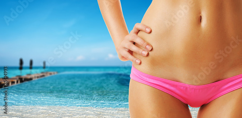 Woman at tropical swimming pool