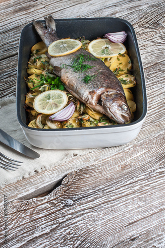 Baked trout with potatoes.