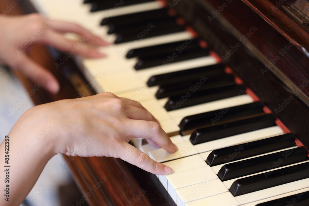 Fototapeta premium hands playing the classic wood piano