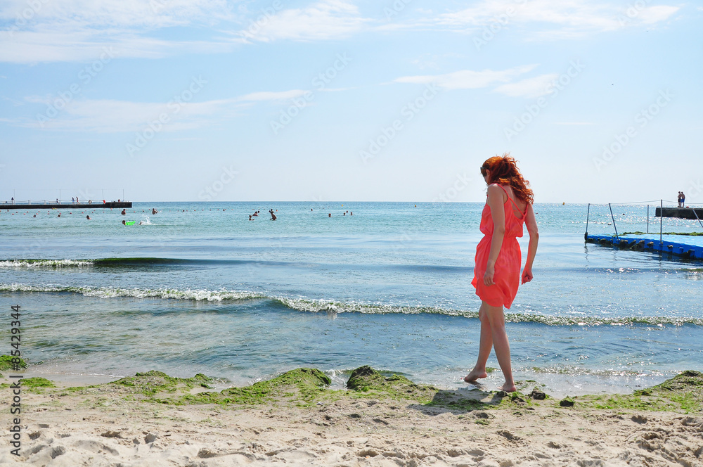 Red-haired girl near the sea