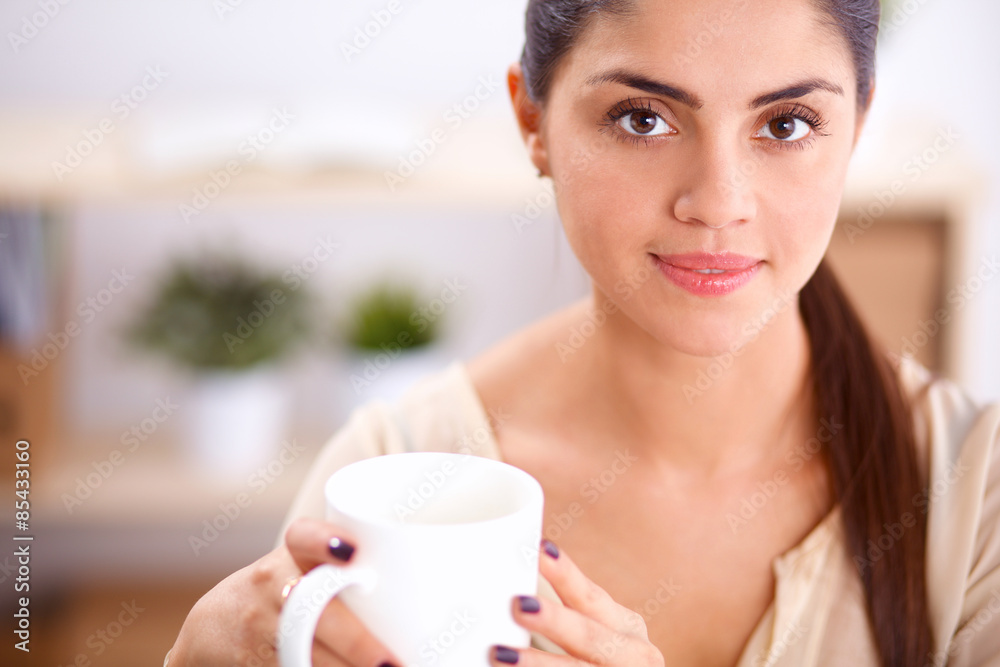 Beautiful businesswoman enjoying coffee in bright office Beautiful businesswoman enjoying coffee in bright office