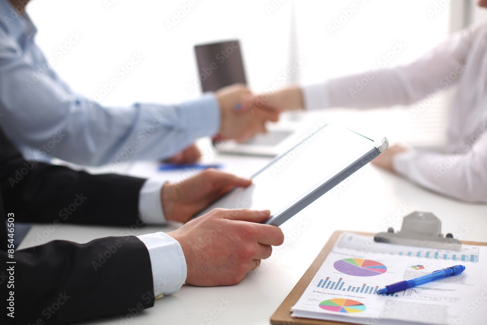 Closeup of a business handshake, on white background Closeup of a business handshake, on white background