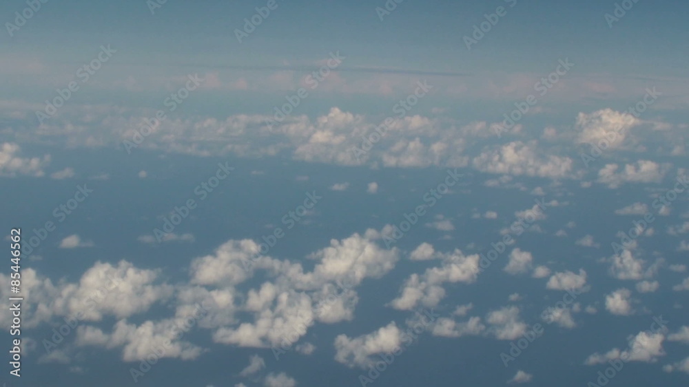 Aerial of clouds over the sea with blue sky.
shooting from inside an airplane. Aerial of clouds over the sea with blue sky.
shooting from inside an airplane.