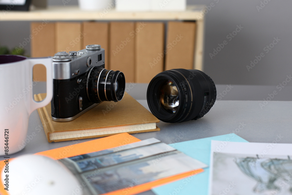 Designers table with camera and tools - obrazy, fototapety, plakaty 