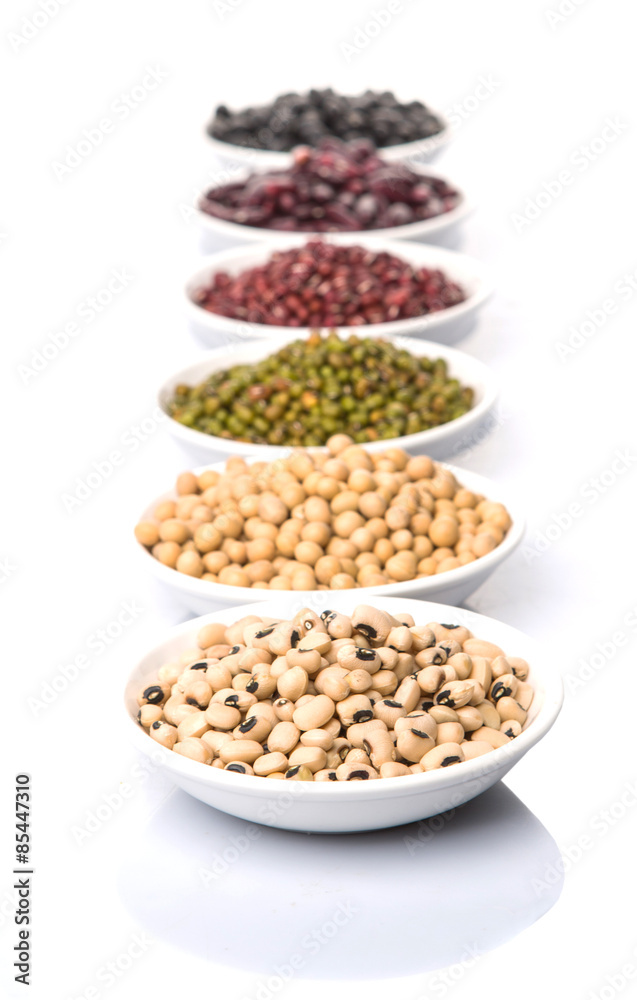 Beans variety in white bowl over white background Beans variety in white bowl over white background