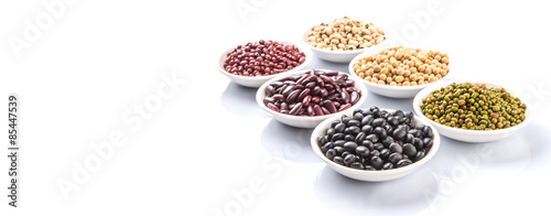 Beans variety in white bowl over white background
