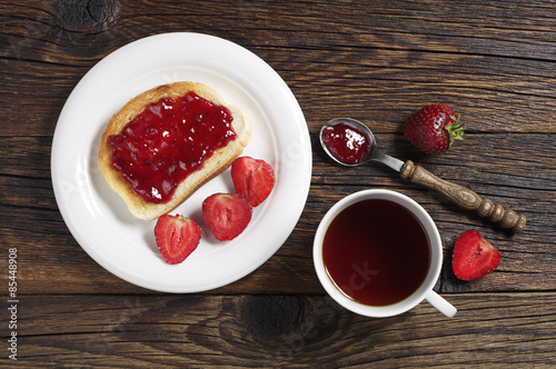 Tea cup and toast with strawberry jam