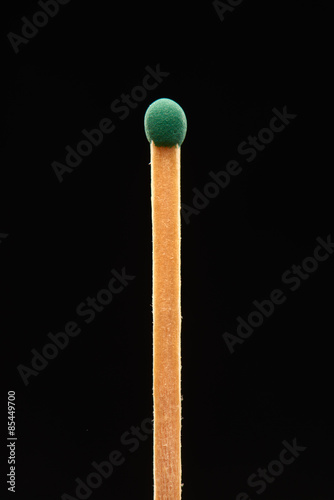 Green match isolated on black background