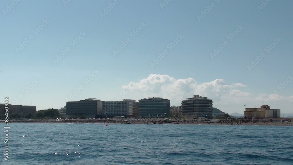 Tracking shot of the coast of Rhodes.
Can see the beach and office buildings in the background.
Filmed from a boat. Tracking shot of the coast of Rhodes.
Can see the beach and office buildings in the background.
Filmed from a boat.
