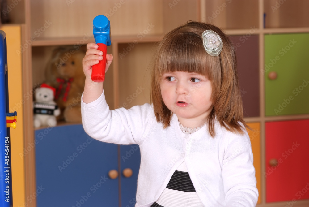 Two-year girl playing and learning in preschool Two-year girl playing and learning in preschool