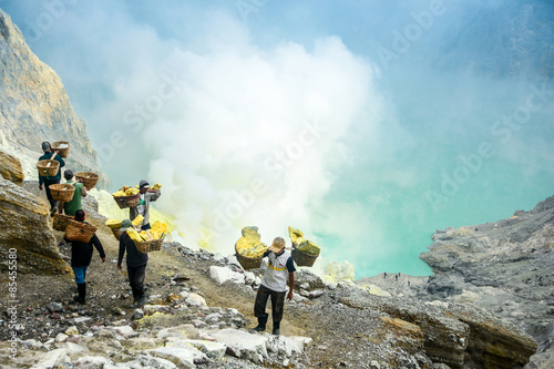 Sulfur miners in Kawah Ijen, Java, Indonesia photo