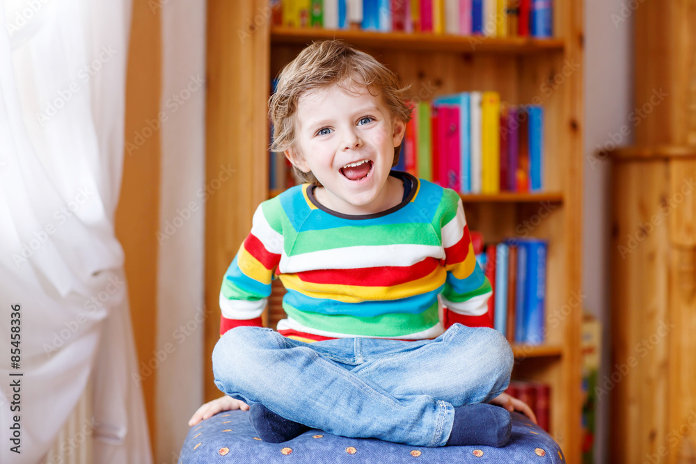 Little blond kid boy having fun and smiling, indoors Little blond kid boy having fun and smiling, indoors