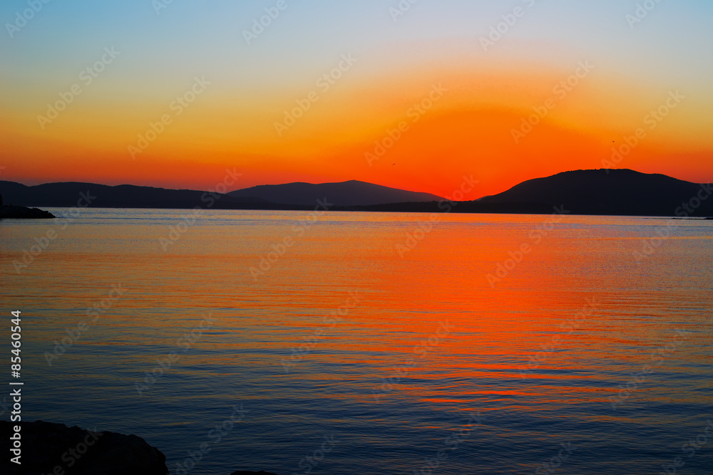 Fototapeta premium orange sunset in Alghero on a clear day,