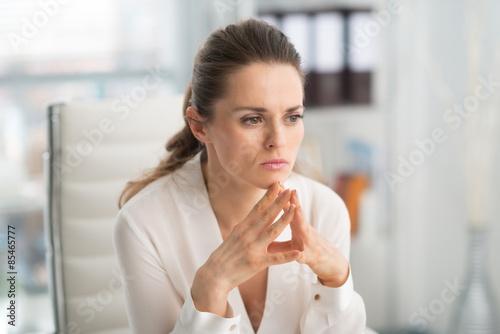 Fotografija Pensive businesswoman with hands in steeple position