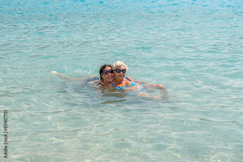 Women are in shallow water of Oludeniz beach, Turkey.